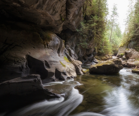 Serene river flowing through a rocky landscape in Huson, Montana