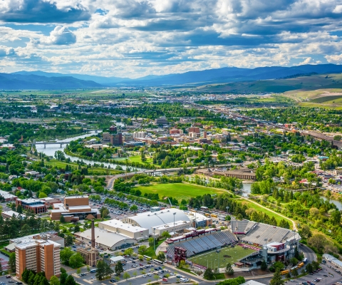 Cityscape of Missoula, Montana with mountain backdrop